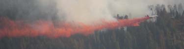 Air tanker dropping retardant on a fire